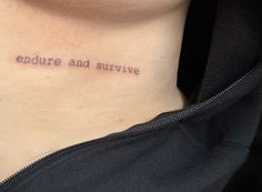 a woman's neck with the words, explore and survive tattooed on her chest