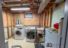 a room with dryer, washer and dryer in the middle of it