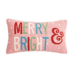 a pink pillow with merry and bright embroidered on it