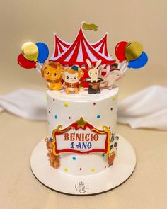 a birthday cake decorated with animals and balloons