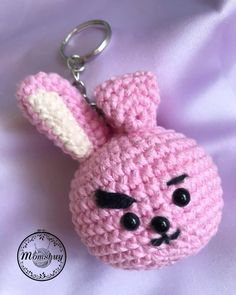 a crocheted keychain with a pink bunny on it's face