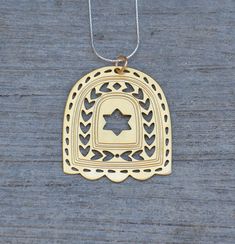 Ornament Gold Hamsa and Star of David Unique Ethnic Design Jewish Symbol Nature Inspired Handmade in Israel  Tribal Pendant Artisan Necklace  This unique design is part of my Judaica collection influence by memories from my childhood rooted in the Kabbala city of Safed. Designed and Handmade by Lea Ben Arye Ein Hod Artists' Village Israel About my journey-  I live and create in Ein Hod artists' village Israel inspired by art and nature that surrounds me.  I am a fabric and jewelry designer.  Ein Hod nestles on a hill surrounding by an olive grove overlooking the Mediterranean Sea.  There are about 300 artists living and creating in varies fields of arts.   Since 1985, I exhibit my art works at "Art & Wear Gallery" which I founded, located at Ein Hod village center.  In addition, over the y Jewish Symbol, Football Necklace, Nature Symbols, Jewish Symbols, Gold Hamsa, Artisan Necklace, Packing Jewelry, Ethnic Design, Antique Hardware