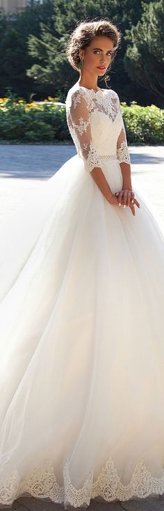 a woman in a white wedding dress posing for the camera with her hand on her hip