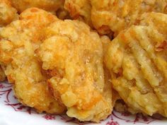 some fried food on a red and white plate