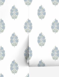 an image of a wallpaper with blue flowers on white and grey background, as well as the corner of a piece of paper that has been cut out