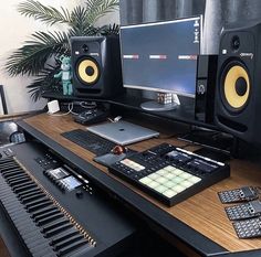 there is a keyboard and two monitors on the desk with other equipment in front of it