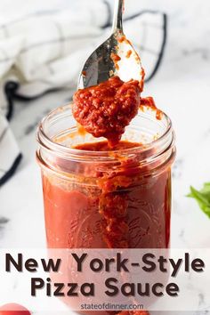 new york style pizza sauce in a glass jar with a spoon sticking out of it