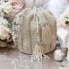 Introducing our exquisite Bridal Potli Bag in Ivory, a perfect accessory for your wedding day. Crafted from luxurious raw silk, this potli bag embodies elegance and sophistication. The delicate beadwork and sparkling crystal embellishments adorn the bag, adding a touch of opulence and grace. The bag features a stunning handmade handle, intricately embellished with beads and crystals, offering both beauty and functionality. Designed to complement your bridal attire, this potli bag is the ideal choice to carry your essentials in style. Let this timeless piece add a final touch of luxury to your special day. Bags Patterns, Potli Bag, Bridal Attire, Diy Bags Patterns, Wristlet Bag, Potli Bags, Diy Bags, Final Touch, Pakistani Wedding