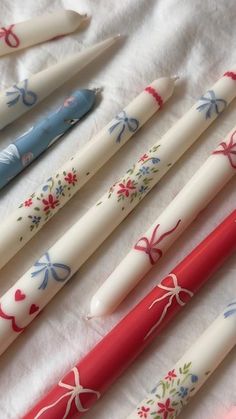 four pens with bows on them are lined up