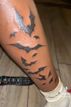 a person with a bat tattoo on their leg