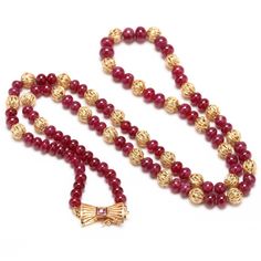 Surprise your July birthday girl (or treat yourself) with this gorgeous necklace! This exquisite necklace is approximately 20 1/2 inches long and is strung with 84 ruby rondelle beads, each measuring between 5.64 and 4.45 millimeters in diameter, and weighing an estimated total of 92 carats. The rubies alternate with 14 karat solid yellow gold filigree beads (5.5 millimeters in diameter) and terminating in a gold butterfly clasp bezel-set with a princess-cut ruby accent measuring 2 millimeters s Anniversary Necklace With 17 Jewels And Round Beads, Anniversary Necklaces With 17 Jewels And Round Beads, Classic Gold Necklace With Gemstone Beads, Vintage Yellow Gold Single Strand Necklace, Fine Jewelry Necklaces With Round Beads For Anniversary, Formal Yellow Gold Necklaces With Gemstone Beads, Formal Yellow Gold Necklace With Gemstone Beads, Formal Yellow Gold Rondelle Necklace, Gold Necklaces With Gemstone Beads For Anniversary