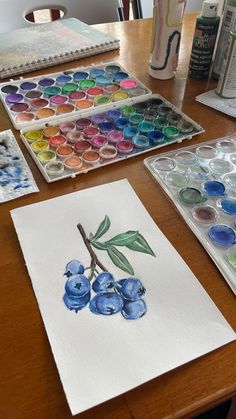 some watercolors are sitting on a table