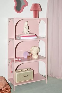 a pink shelf with some items on it