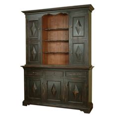 an old fashioned china cabinet with wooden doors and drawers on the front, in dark green