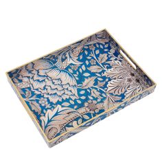 a decorative blue and white box with flowers on the inside, sitting on a white surface