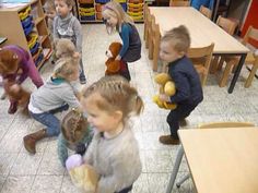 children playing with stuffed animals in a classroom