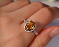 Gorgeous 8*12 mm oval Citrine ring, made with 925 sterling silver, plated with white gold. Main Stone: 8*12 mm Natural Citrine Side Stone: CZ Need other size please contact. CS0100 Yellow Oval Topaz Rings, Yellow Oval Topaz Ring With Halo Setting, Fine Jewelry Yellow Oval Topaz Ring, Yellow Oval Topaz Ring With Center Stone, Oval Topaz Ring With Halo Setting, Yellow Oval Topaz Ring With Accent Stones, Oval Yellow Topaz Ring With Accent Stones, Yellow Oval Halo Jewelry, Oval Citrine Topaz Ring In White Gold