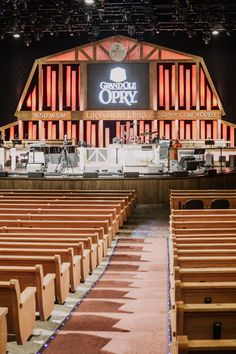 the inside of an empty church with rows of wooden pews in front of it