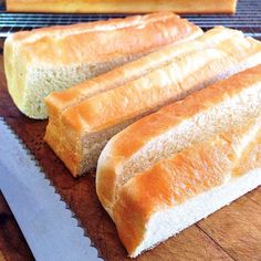 three loaves of bread sitting on top of a cutting board