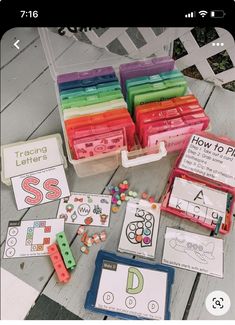 a table topped with lots of different types of letters and numbers next to boxes filled with legos