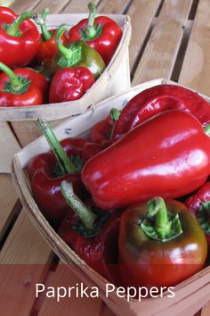 two baskets filled with red and green peppers on top of a wooden table next to each other