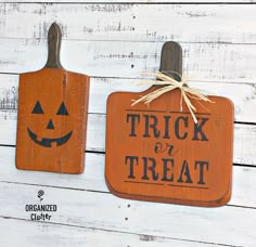 two wooden cutting boards decorated with jack - o'- lanterns and the words trick or treat on them