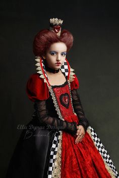 a woman in a red and black dress with a crown on top of her head