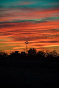 an orange and blue sky with some clouds