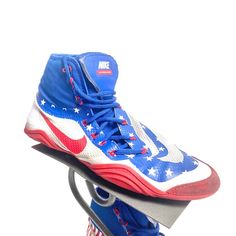 a pair of blue and white shoes with red, white, and blue stars on them