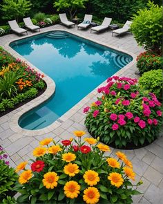 a swimming pool surrounded by flowers and chairs