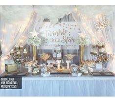 a table topped with lots of food and desserts next to a white curtained wall