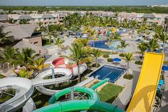 an aerial view of a resort with water slides and palm trees