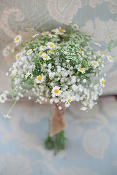 a bouquet of daisies and baby's breath is displayed on the instagram page