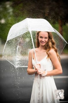 a woman standing under an umbrella in the rain