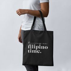 "RUNNING ON FILIPINO TIME  = 100% relatable. A black eco tote bag. Original design by a female FILIPINX maker. * 100% certified organic cotton, direct-to-fabric print (graphic may shift during printing process and may not be completely centered) * Dimensions: 16\" x 14 ½\" x 5\" * Weight limit: 30lbs (13.6 kg) * Made-to-order, fulfilled and shipped from a 3rd party. Some items in your order may ship separately - like mugs and prints, depending on the packaging type.* * Please note, I cannot add Black Canvas Tote Bag For Daily Use, Black Tote Canvas Bag For Daily Use, Black Tote Canvas Bag For Daily Life, Eco-friendly Black Canvas Shoulder Bag, Black Eco-friendly Canvas Shoulder Bag, Filipino Design Ideas, Black Canvas Tote Bag, Eco Tote Bag, Filipino Food