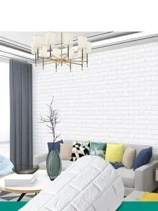 a living room filled with furniture and a white brick wall