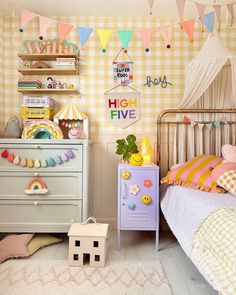 a child's bedroom decorated in pastel colors and gingham wallpaper