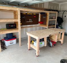 two workbenches in a garage with tools on the table and shelves above them