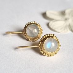 Antique style solid gold drop round moonstone earrings, feminine romantic jewelry, bridal earrings for women, available in 9k or 14k yellow gold. Delicate handmade round gold earrings set with light rainbow moonstone gems and embellished with delicate granules, adding an antique touch to their style. They are available in 9k or 14k yellow gold. The earrings are delicate and romantic, making them highly suitable for a bride. They are perfect for adding a touch of glamour to any outfit and will st Hand Forged Wedding Earrings, Gold Hand-forged Moonstone Earrings, Gold Hand Forged Moonstone Earrings, Gold Moonstone Hand Forged Earrings, Hand Forged Gold Moonstone Earrings, Handmade Yellow Gold Moonstone Earrings, Moonstone Round Yellow Gold Earrings, Round Moonstone Yellow Gold Earrings, Moonstone Yellow Gold Round Earrings