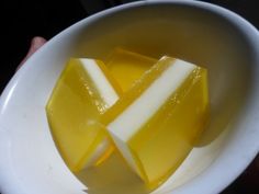 two pieces of yellow and white candy in a bowl