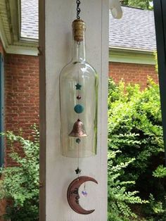 a glass bottle hanging from the side of a building with a moon and star in it