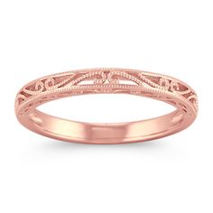 a rose gold wedding ring with filigrees