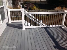 a deck with white railing and black rails