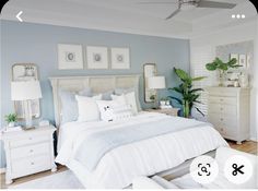 a bedroom with blue walls and white furniture