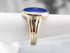 This vintage ring dates to the 1940s and has a handsome geometric, all in highly polished green gold! Particularly nice is the oval- cut lapis cabochon center, original to the piece, which makes this a truly treasured estate piece! Metal: 14K Green Gold Gem: Lapis Gem Measurements: 12.5 x 15.5 mm, Oval Ring Size: 10.50 Marks: "14" Stamped on the inside band Classic Domed Cabochon Signet Ring, Classic Domed Sapphire Ring With Polished Finish, Classic Opal Ring With Polished Oval Cabochon, Classic Opal Ring With Oval Cabochon And Polished Finish, Classic Lapis Lazuli Ring With Polished Finish, Classic Oval Cabochon Dome Ring With Polished Finish, Classic Blue Oval Cabochon Signet Ring, Blue Oval Cabochon Signet Ring With Polished Finish, Classic Opal Ring With Polished Finish For Formal Occasions