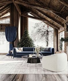 a living room filled with furniture and a christmas tree in the middle of the room