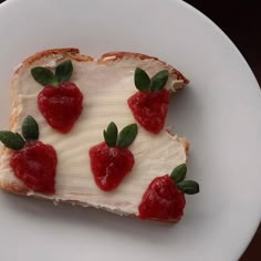 a piece of bread with cream and strawberries on it sitting on a white plate