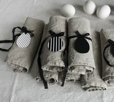 four napkins are wrapped in black and white paper