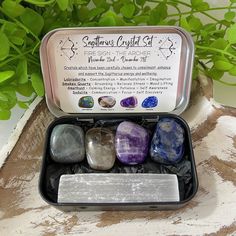 an assortment of stones in a tin on a table