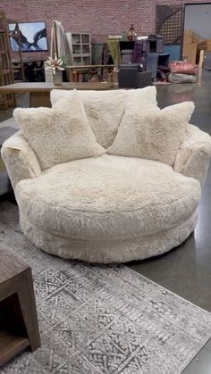 a large round couch sitting on top of a rug